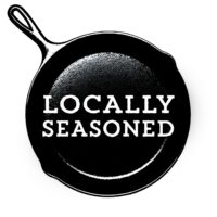 Logo for the company Locally Seasoned. The company name is centered on a cast iron pan